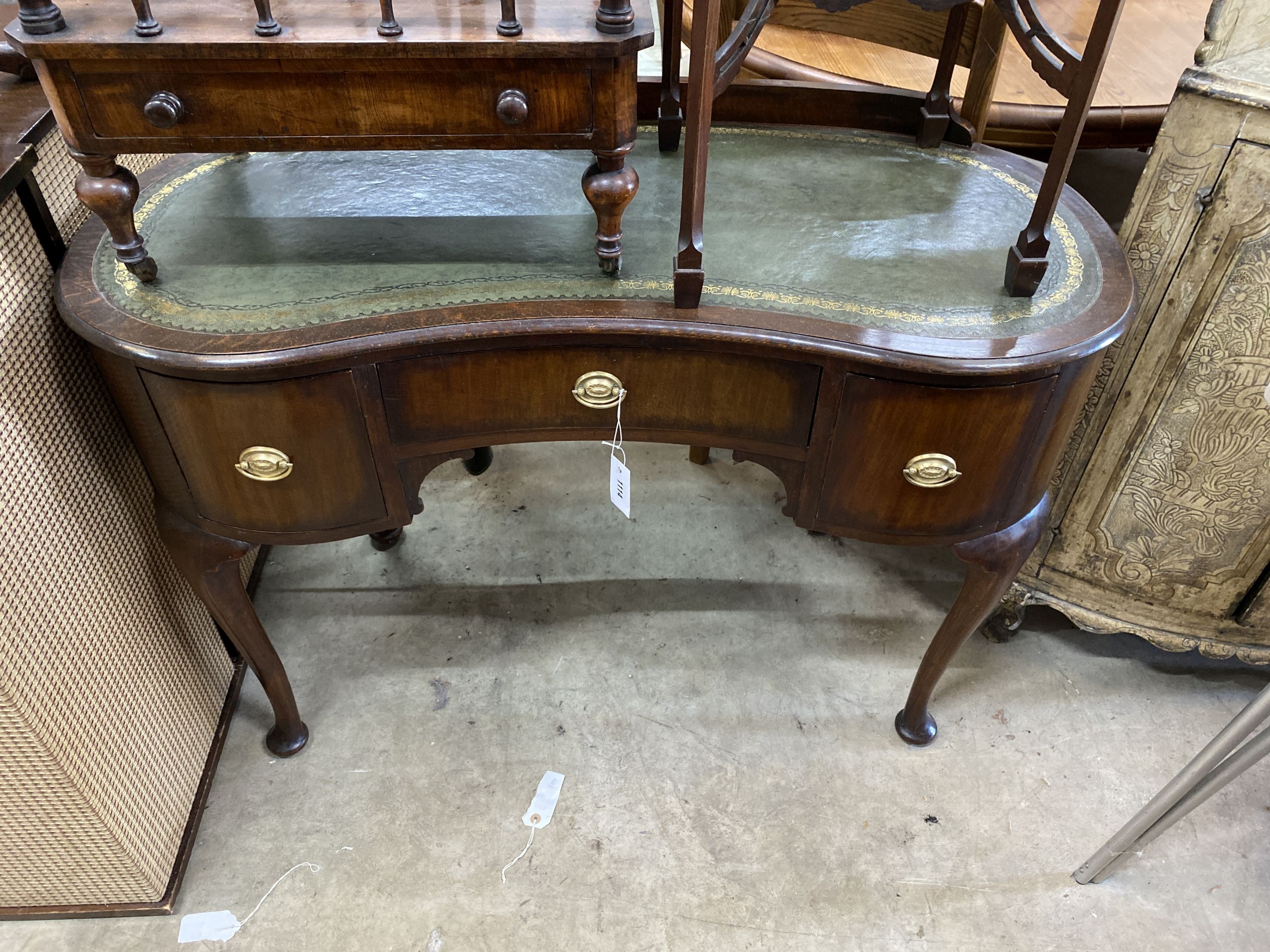 A 1920's kidney shaped writing table, width 110cm, depth 50cm, height 78cm